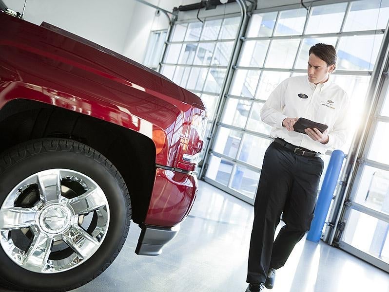 service advisor inspecting vehicle Turan-Foley Chevrolet in Gulfport MS
